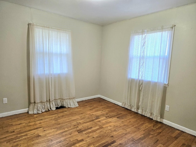 unfurnished room with wood-type flooring