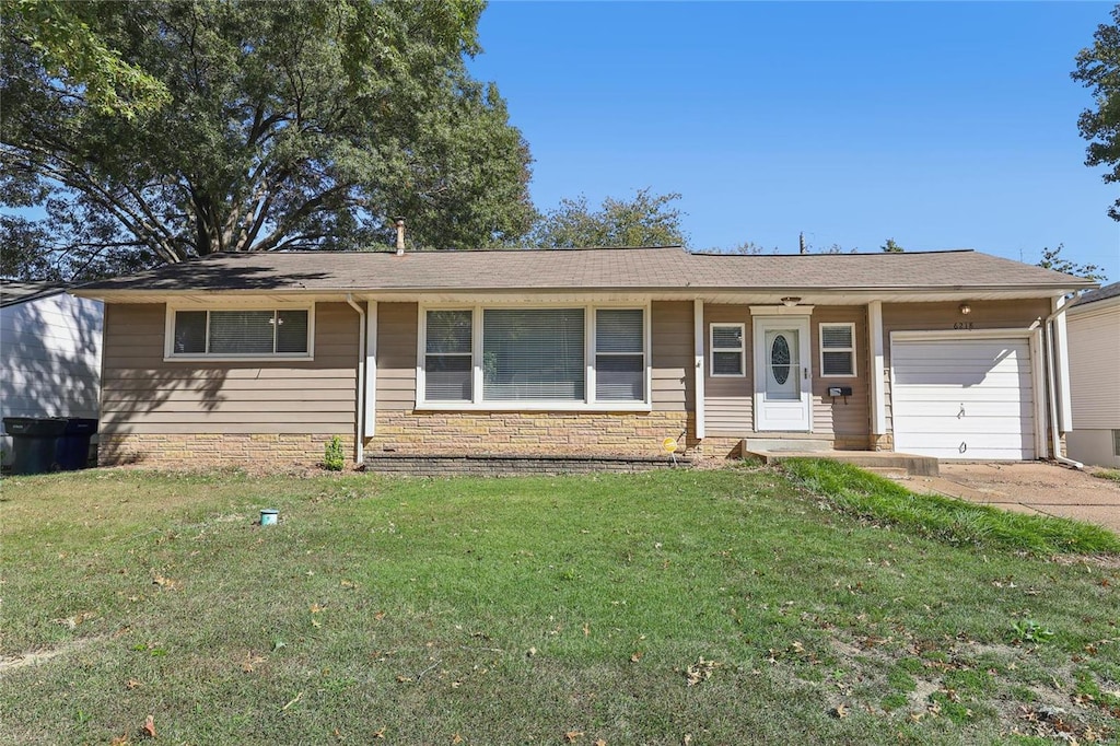 ranch-style home with a front lawn and a garage