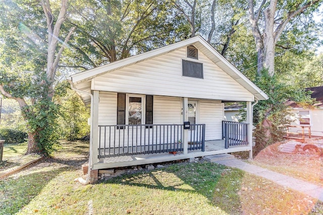 bungalow-style home featuring a porch and a front lawn