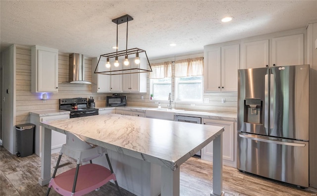 kitchen featuring wall chimney exhaust hood, white cabinetry, black appliances, and a textured ceiling