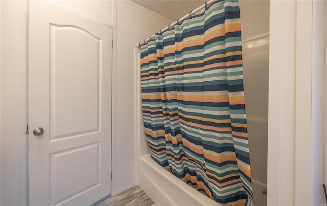 bathroom with a textured ceiling and hardwood / wood-style flooring