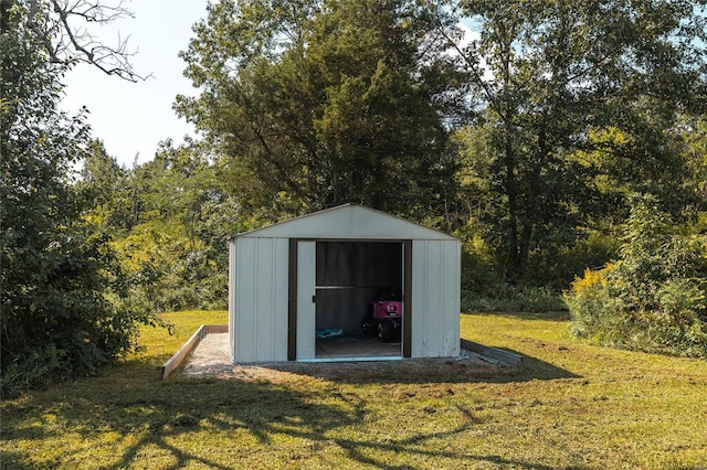 view of outbuilding with a yard