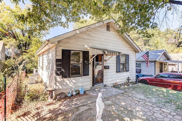 bungalow-style home with central AC unit