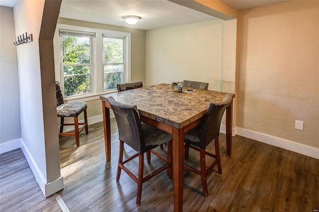 dining area featuring dark hardwood / wood-style flooring