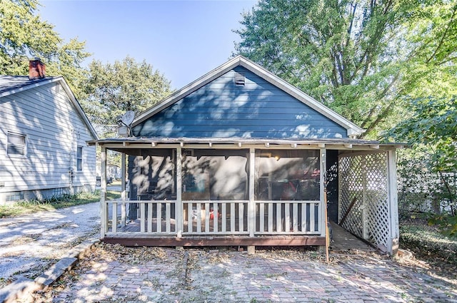 back of house with a sunroom