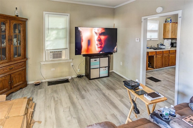 living room with crown molding, cooling unit, and light wood-type flooring