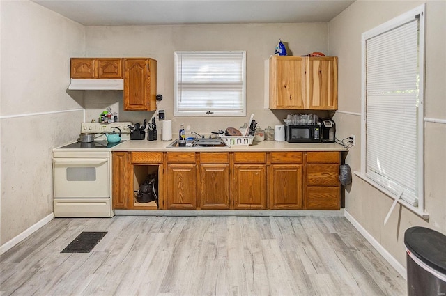 kitchen with sink, white electric range, and light hardwood / wood-style floors