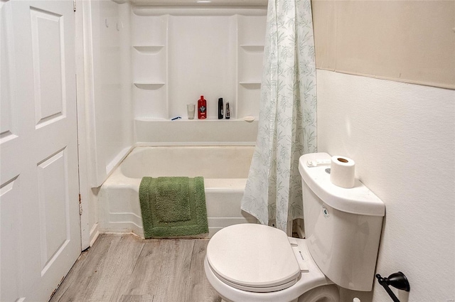 bathroom featuring shower / bath combination with curtain, toilet, and hardwood / wood-style floors