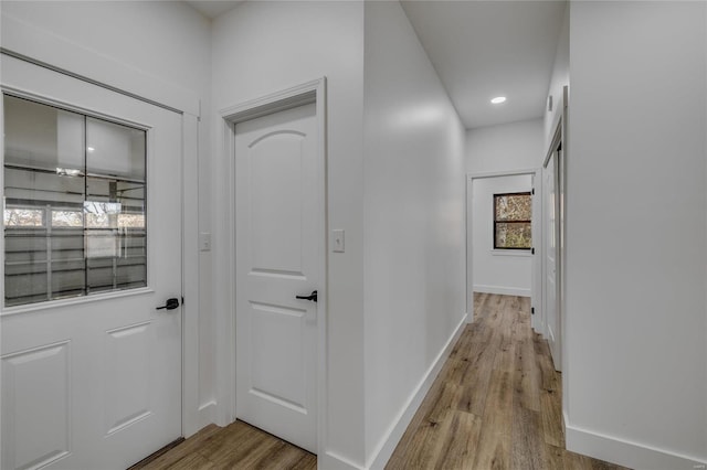 corridor with light hardwood / wood-style floors