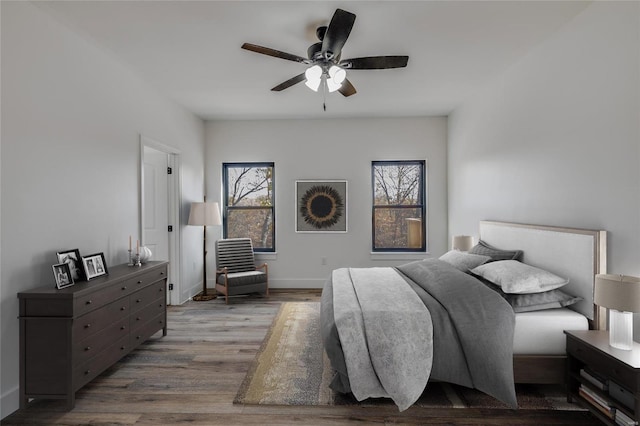 bedroom with ceiling fan and light hardwood / wood-style flooring