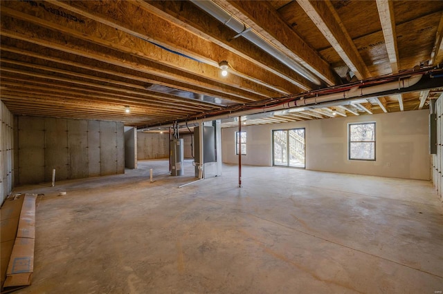 basement featuring water heater and heating unit