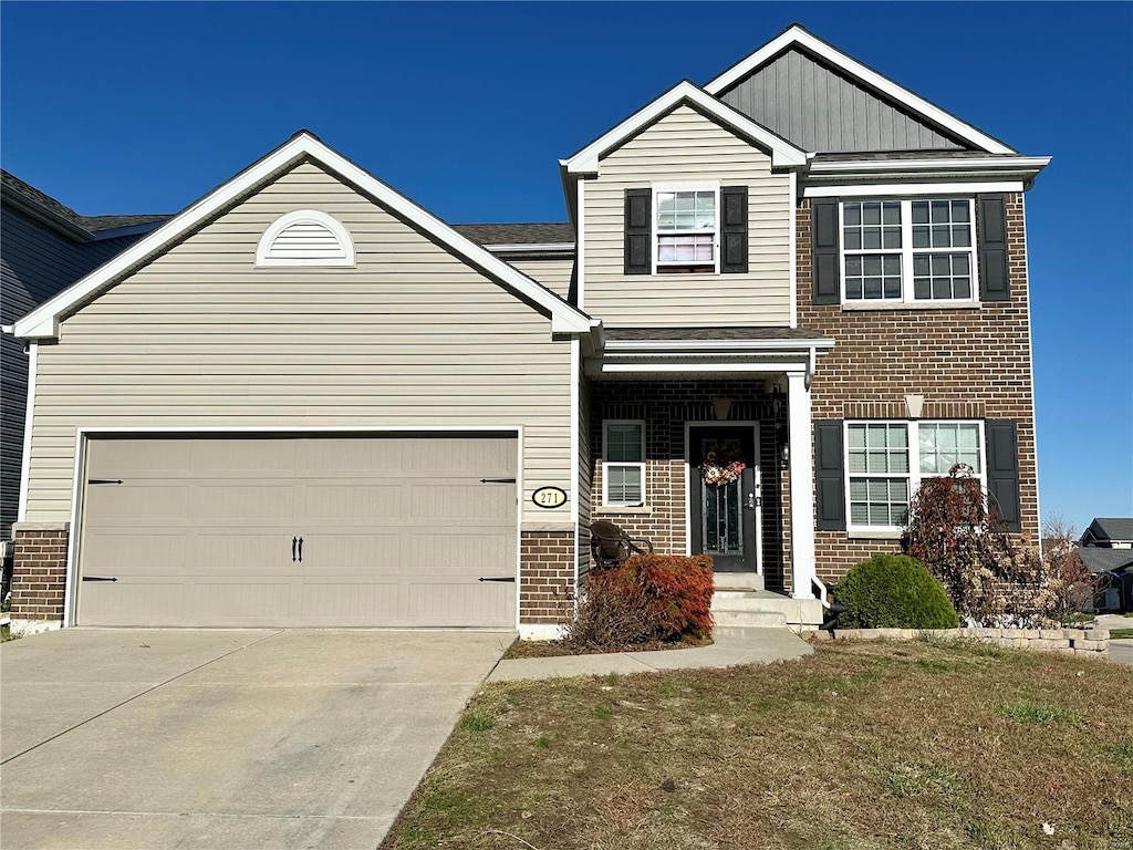 view of front of property with a front lawn and a garage