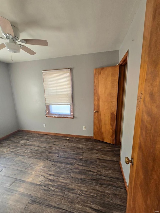 unfurnished room featuring ceiling fan and dark hardwood / wood-style flooring