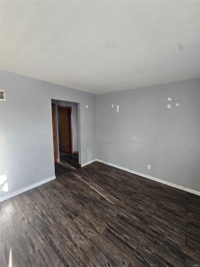 empty room with dark hardwood / wood-style floors