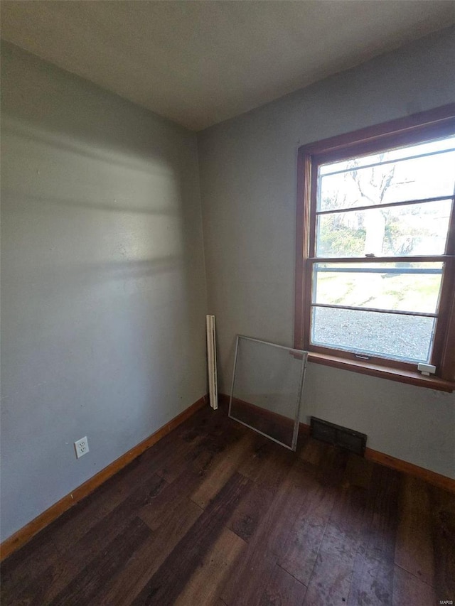 spare room with dark wood-type flooring