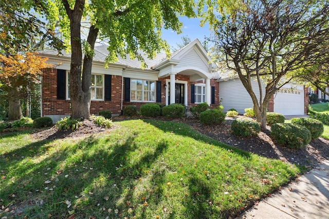 view of front of house with a front yard and a garage