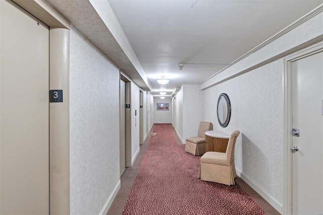 corridor featuring baseboards, a textured wall, elevator, and carpet