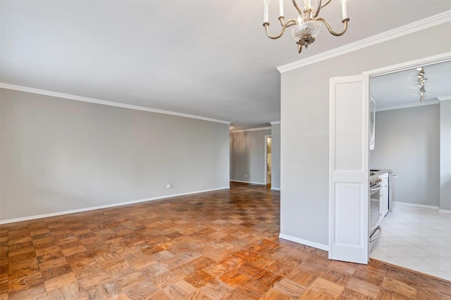 spare room with ornamental molding, baseboards, and a notable chandelier