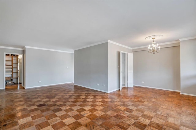 empty room featuring baseboards, a notable chandelier, and ornamental molding