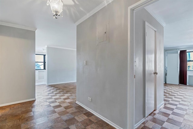 hallway with ornamental molding, tile patterned floors, and plenty of natural light