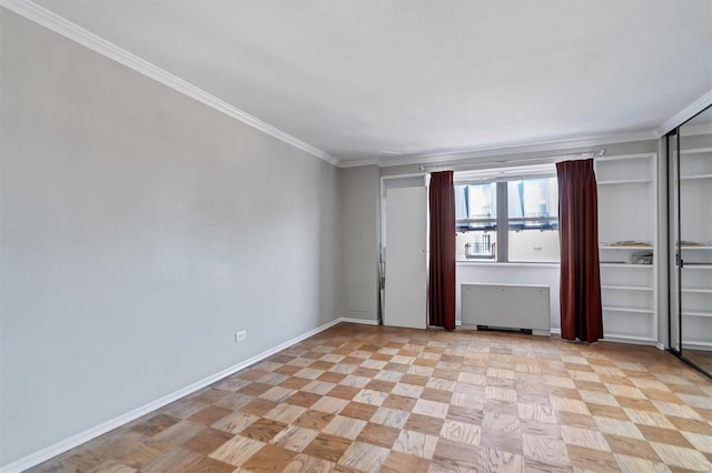 empty room with radiator, crown molding, and baseboards