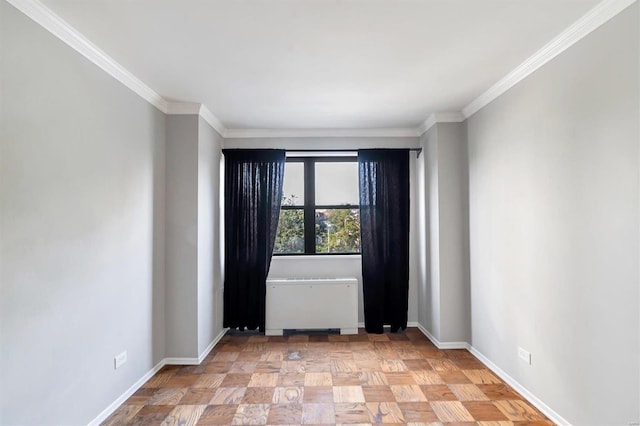 empty room featuring ornamental molding, light parquet floors, and radiator heating unit