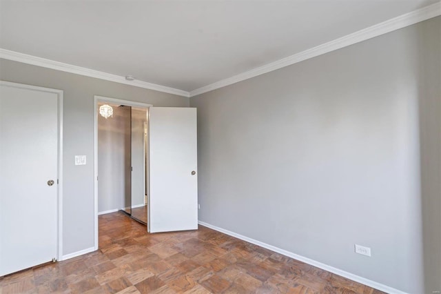 spare room with baseboards and ornamental molding