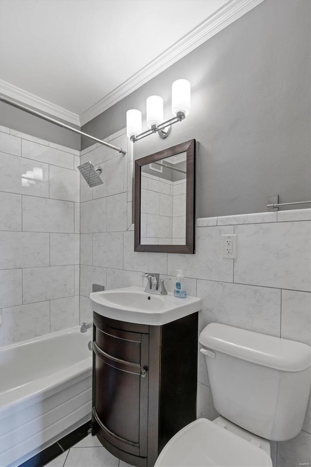 full bathroom featuring tiled shower / bath, tile walls, toilet, vanity, and crown molding