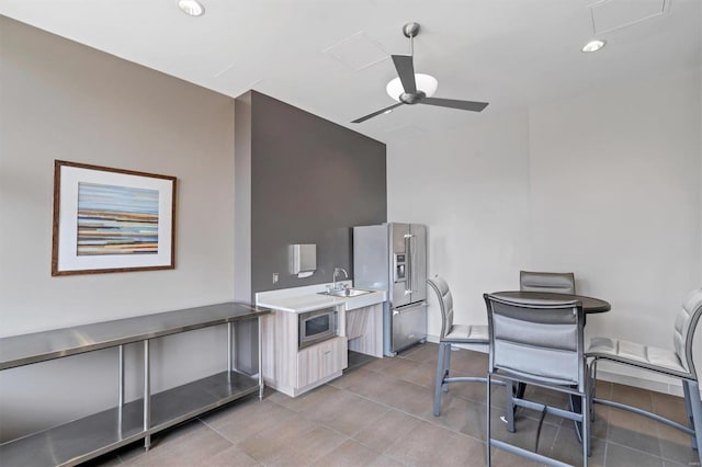 interior space featuring light countertops, light tile patterned floors, modern cabinets, appliances with stainless steel finishes, and ceiling fan