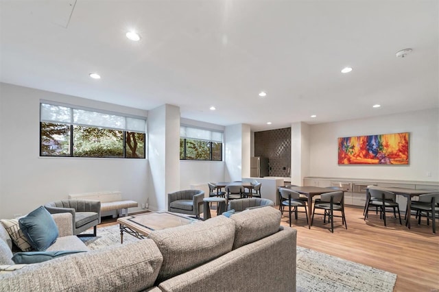 living area featuring light wood-type flooring and recessed lighting