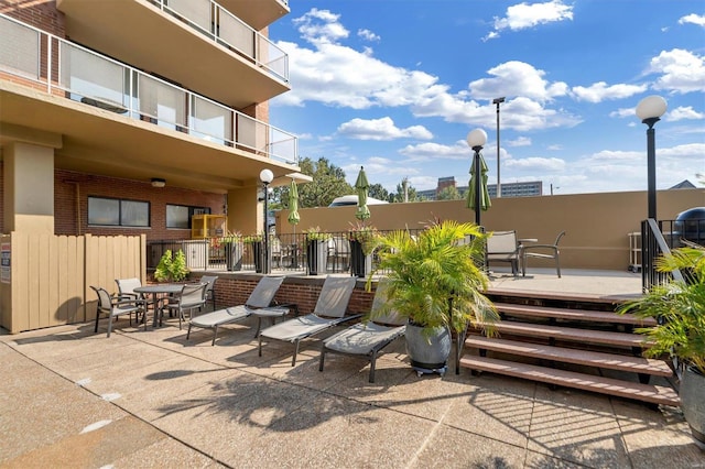 view of patio featuring a balcony