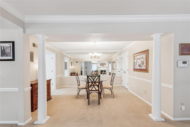 dining area featuring a textured ceiling, ornamental molding, an inviting chandelier, and light colored carpet