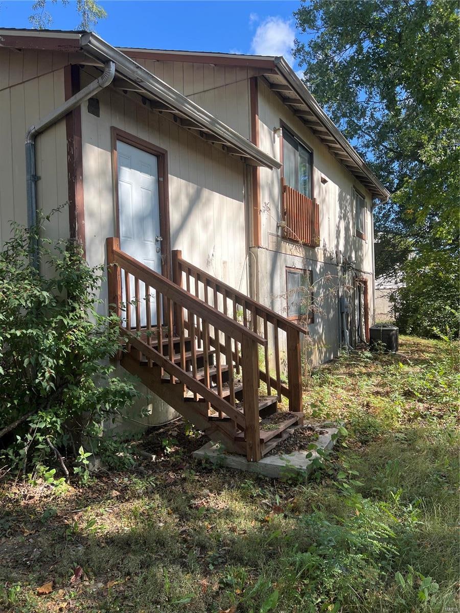 view of side of home featuring central AC unit