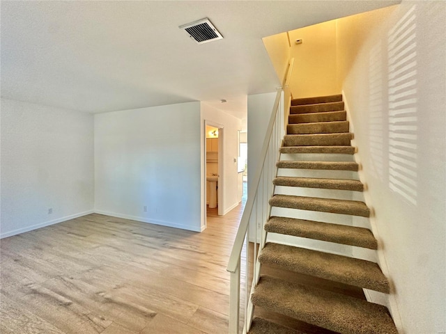 staircase featuring hardwood / wood-style flooring