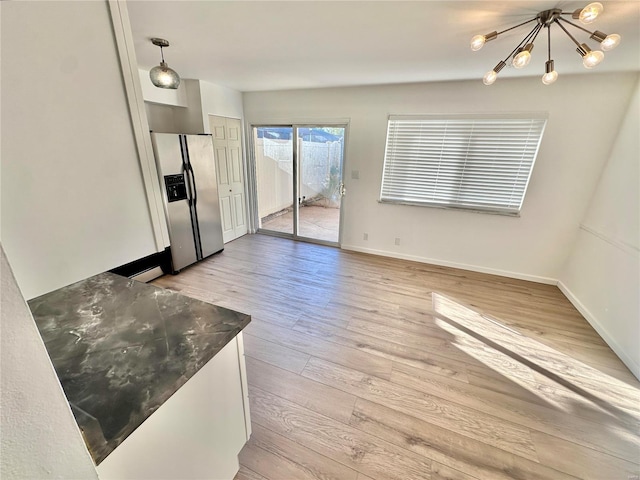 interior space with light hardwood / wood-style flooring and a chandelier