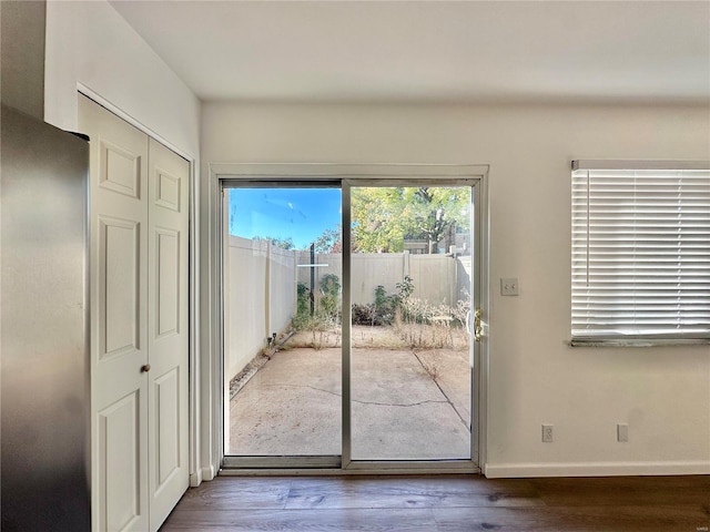 entryway with dark hardwood / wood-style flooring