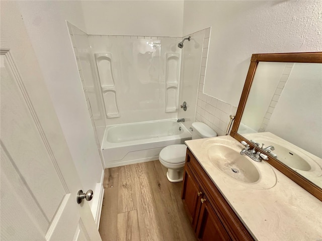 full bathroom with vanity, hardwood / wood-style flooring, toilet, and shower / bath combination