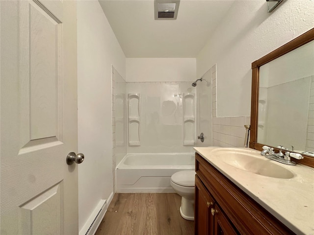 full bathroom with bathtub / shower combination, a baseboard heating unit, wood-type flooring, toilet, and vanity