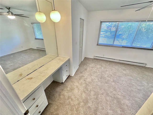 interior space featuring built in desk, ceiling fan, light colored carpet, and baseboard heating