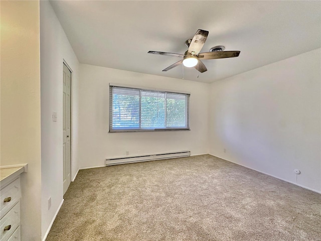 unfurnished bedroom featuring light colored carpet, a baseboard radiator, and ceiling fan