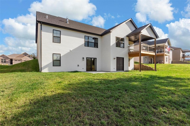 rear view of property with a patio area and a lawn