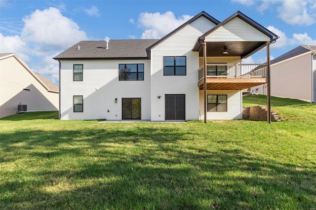 rear view of property with a lawn, central AC unit, and ceiling fan