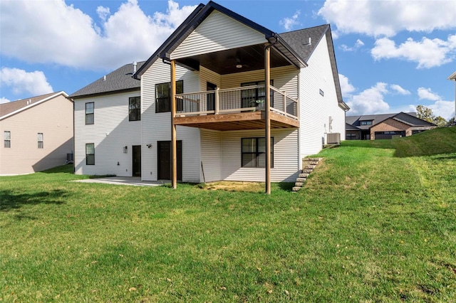 rear view of property featuring a patio area, central AC, a lawn, and a balcony