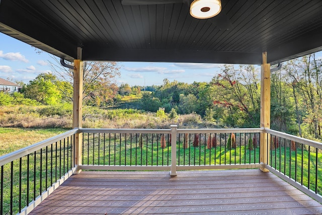 wooden deck featuring a yard