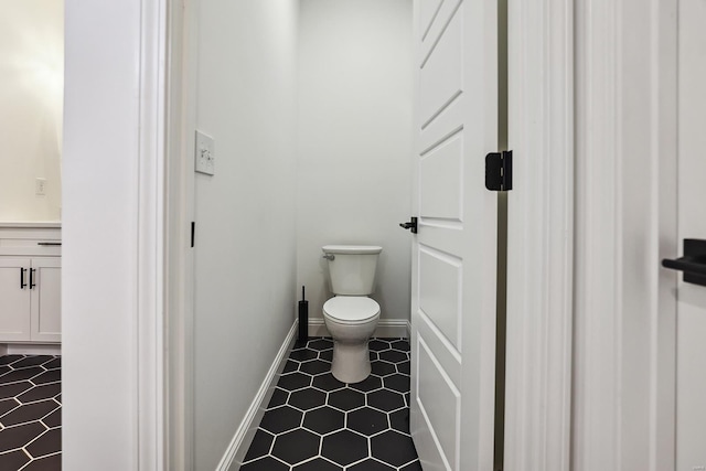 bathroom with toilet and tile patterned floors