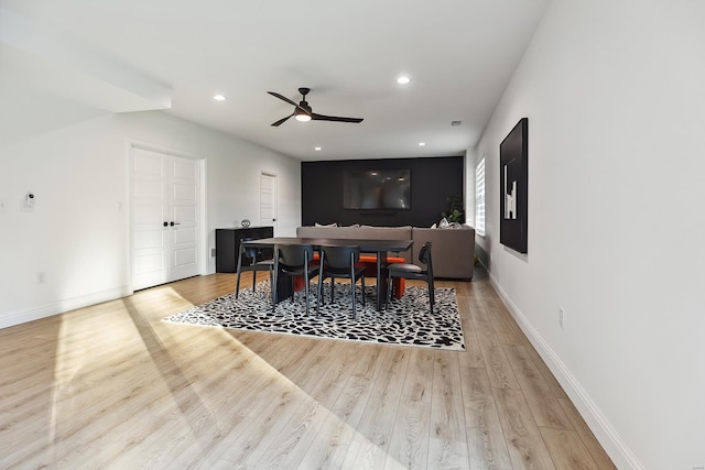 dining room with light hardwood / wood-style floors and ceiling fan