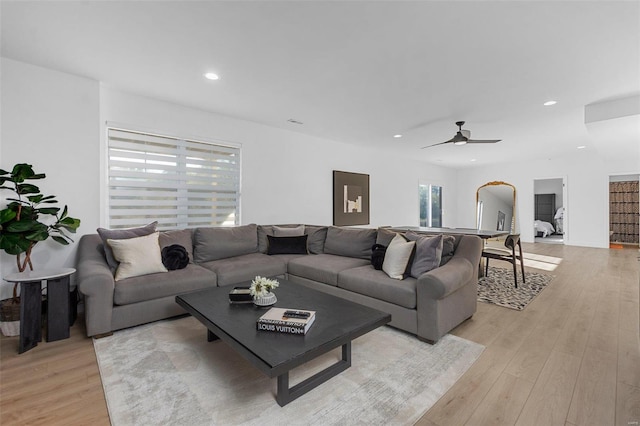 living room featuring light hardwood / wood-style flooring and ceiling fan