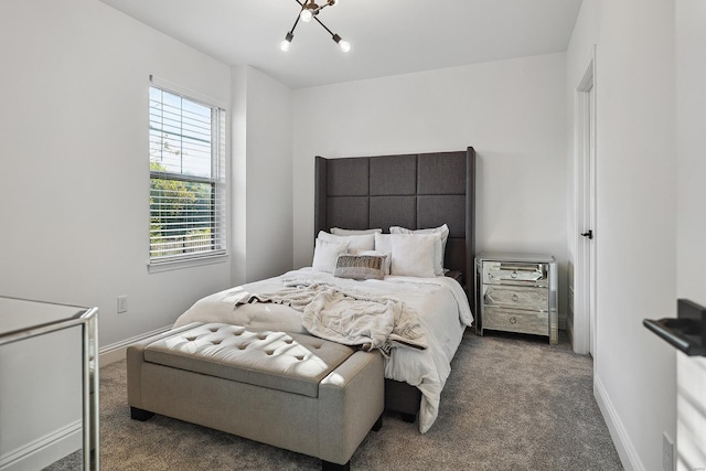 carpeted bedroom with a chandelier