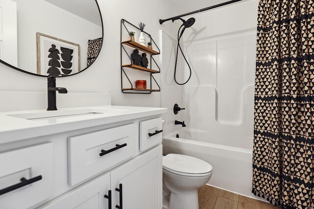 full bathroom featuring vanity, washtub / shower combination, wood-type flooring, and toilet