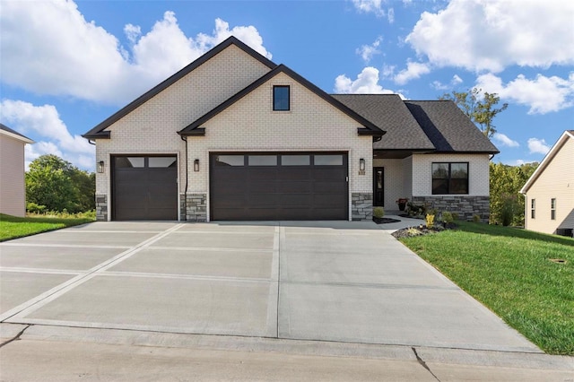 view of front of property featuring a garage and a front lawn